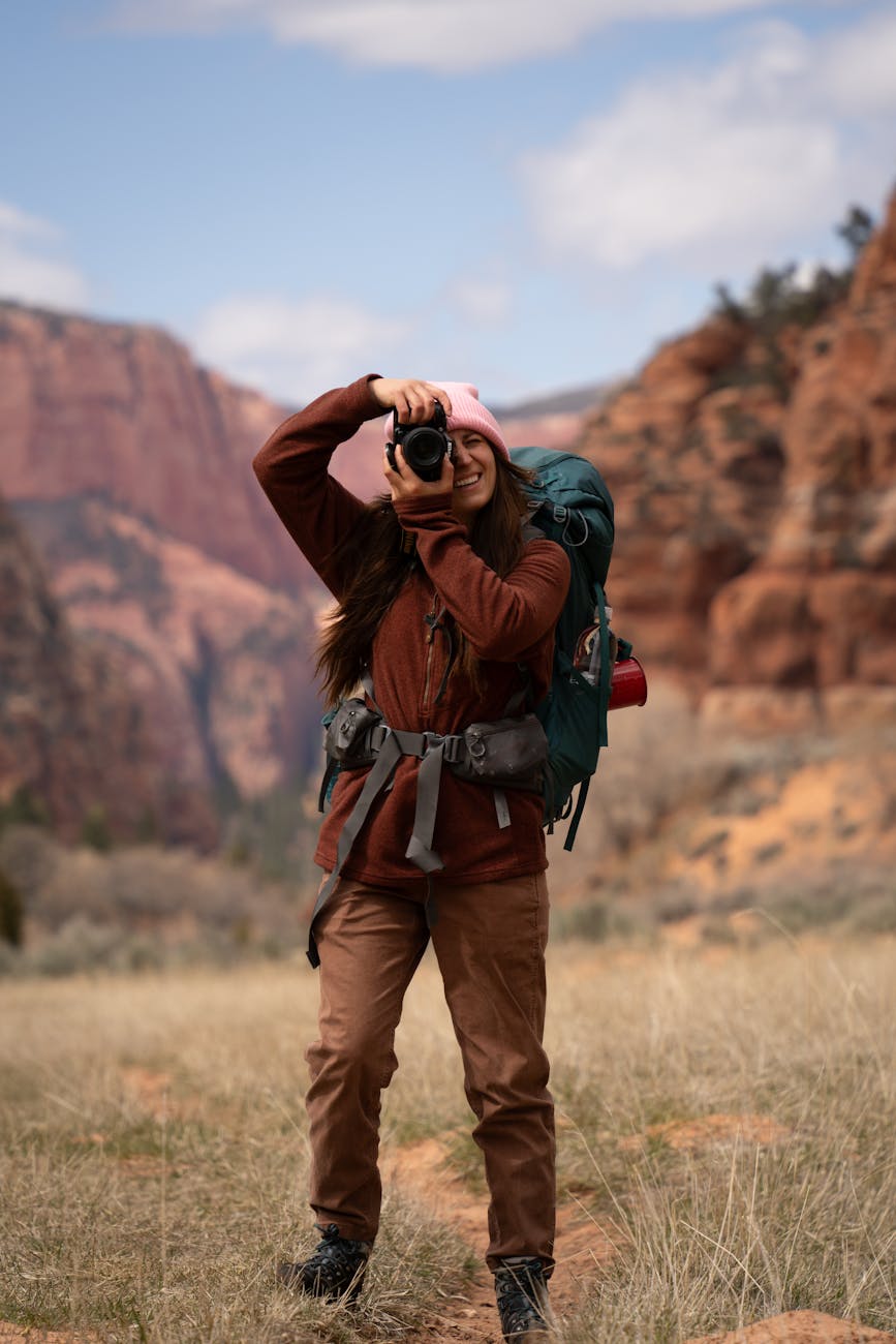 woman hiking and photographing in zion national park in the usa